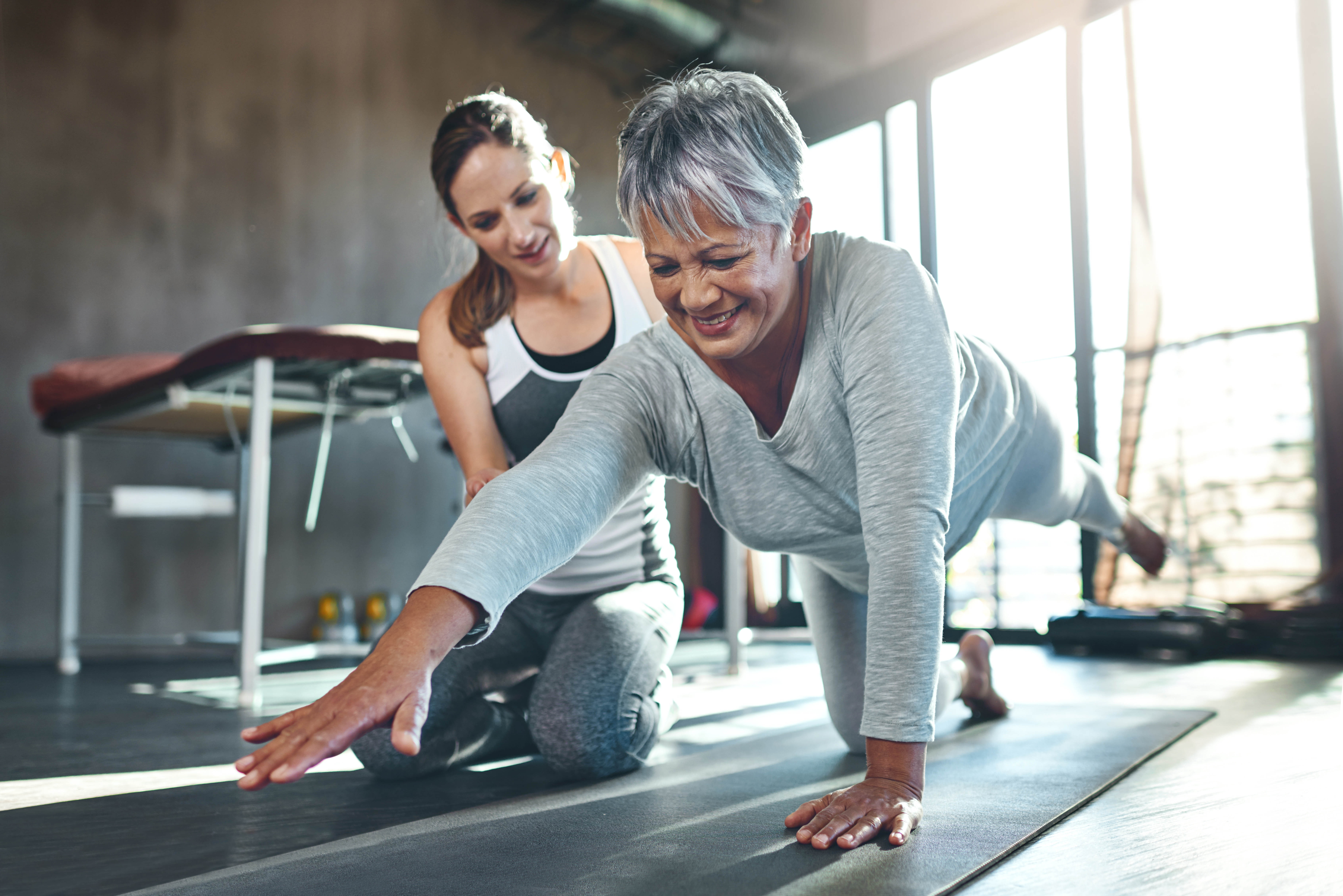 Older woman doing personal training with a female trainer in a gym Older woman doing personal training with a female trainer in a gym